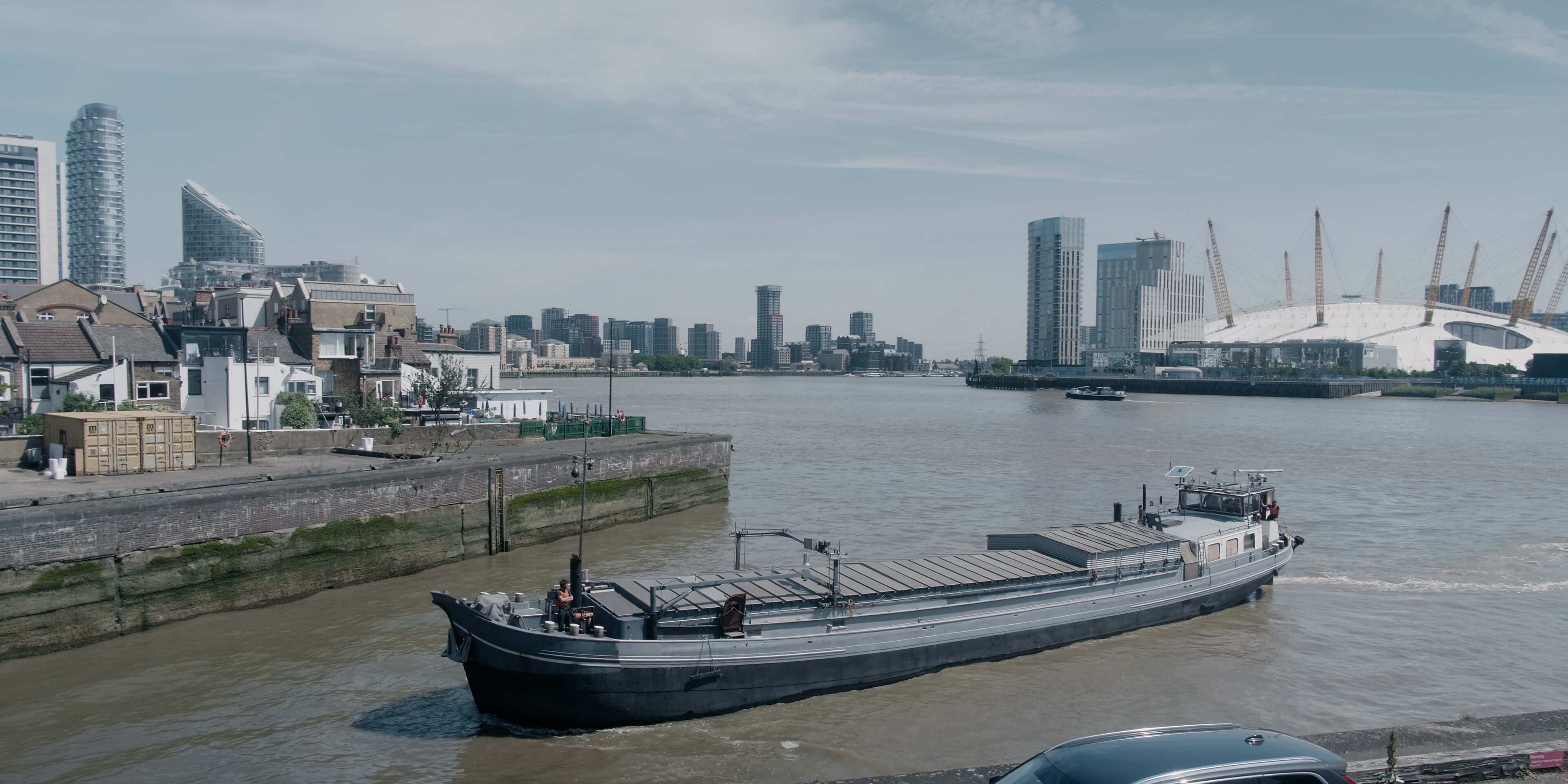 A boat on the river Thames with the O2 arena in the background