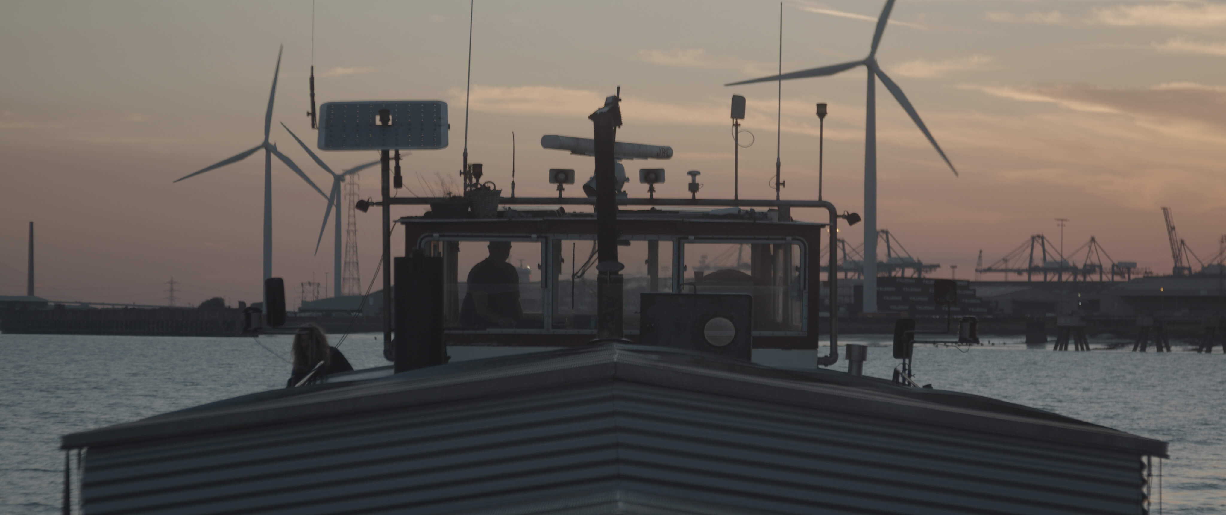 Length of the boat with setting sun in the background