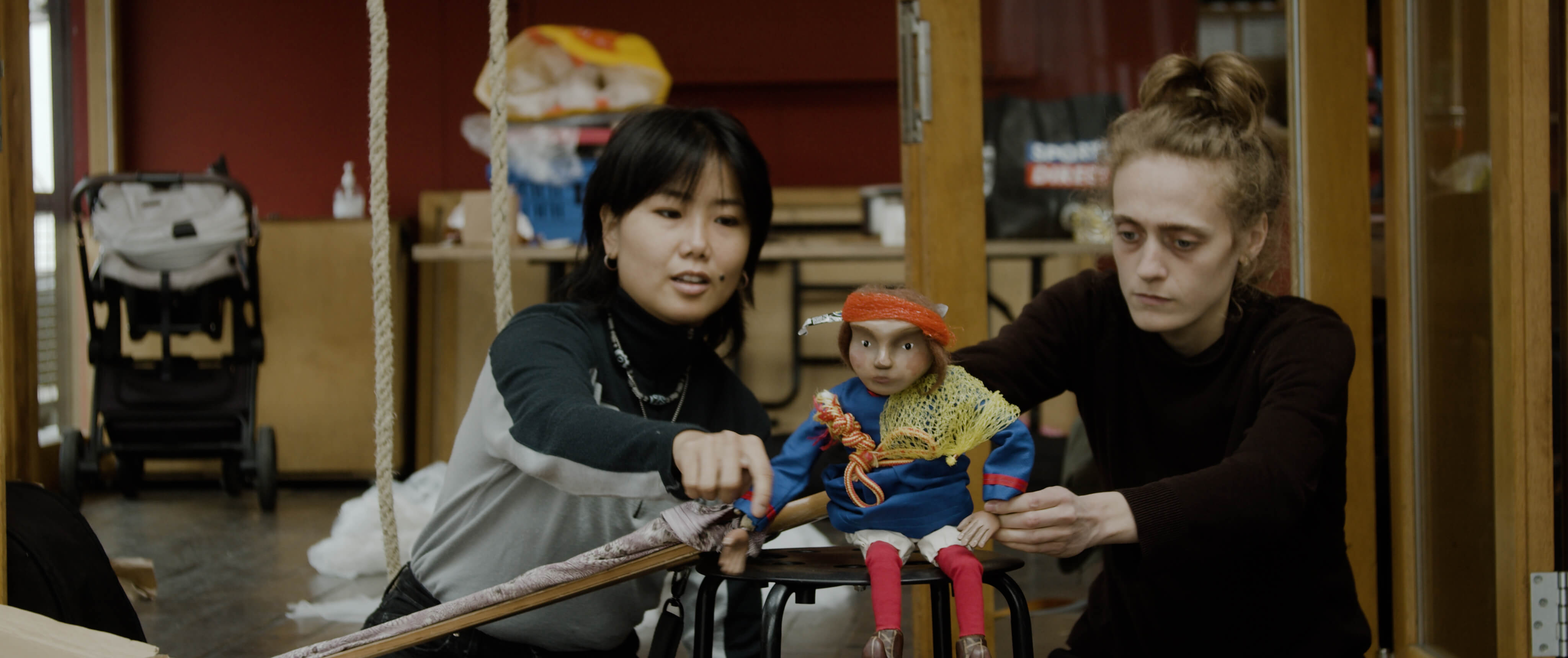 The Whale's Tale, two people manipulating a miniature figure